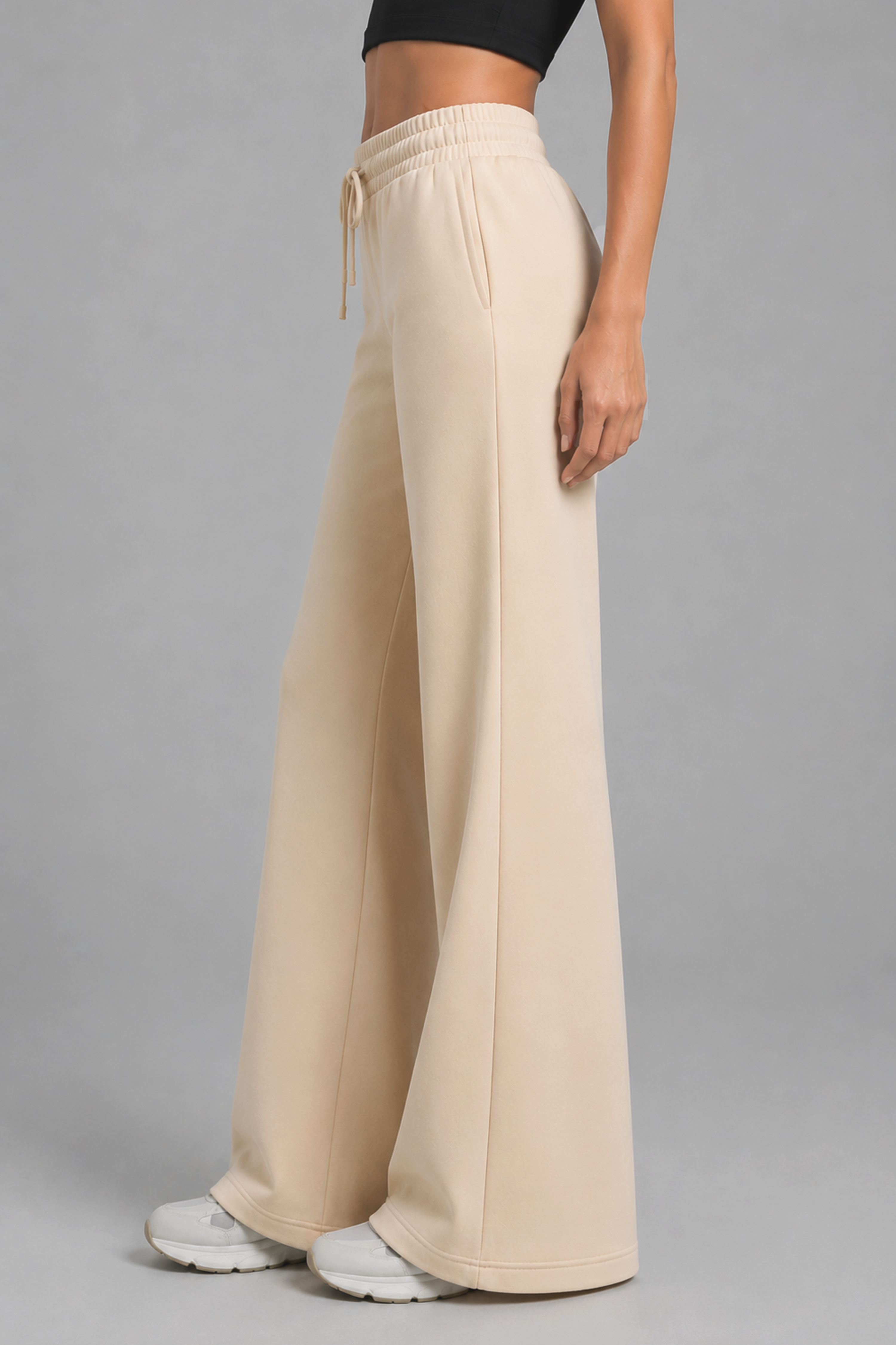 Image of High-waisted beige flared pants with flexible performance fabric
